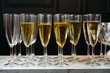 A row of champagne flutes filled with bubbly refreshment, celebrating special occasions. A Toast to Celebration: Wine Glasses in a Row.
