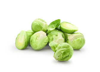 Heap of whole and halved fresh green brussels sprouts vegetable isolated on white background          