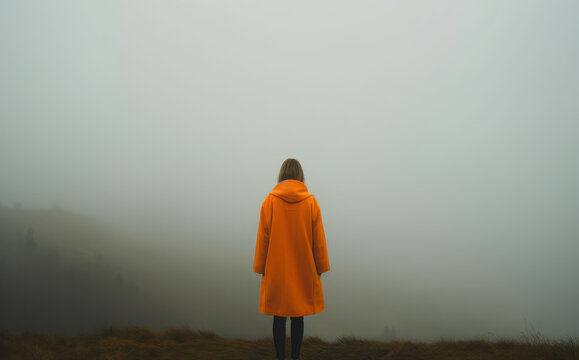 Background image of a woman wearing an orange coat, Lonely woman meditating on nature