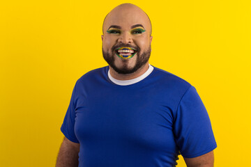Caucasian man with a beard and with celebratory makeup in the colors of Brazil.