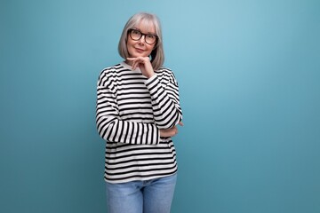 Fototapeta portrait of a pleasant woman 60s in a fashionable image on a bright studio background obraz