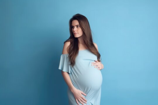 Beautiful pregnant woman standing on blue background. Ai generative.