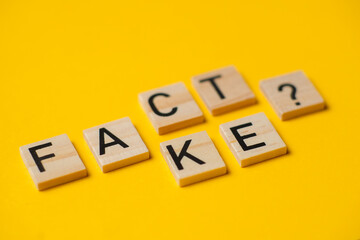 fact or fake words with a question on a yellow background.