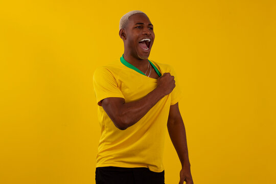 Black-skinned Brazilian man with Brazilian soccer team shirt in studio photo