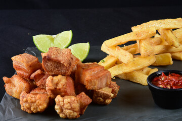 fried pork skin crackling pork pancetta pururuca typical brazilian food with lemon and french fries