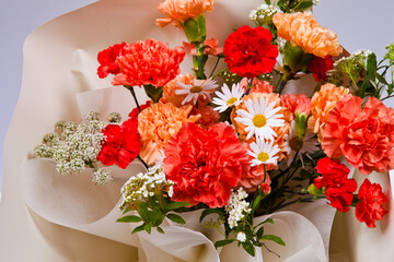 Bouquet of carnations and wildflowers on a white background