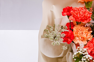 Bouquet of carnations and flowers in a mannequin
