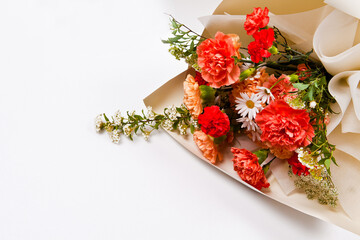 Bouquet of red and orange flowers on a white background.