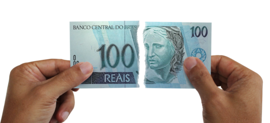 Torn money. Note of 100 reais. Currency of Brazil destroyed. Conceptual idea of ​​wasting money.