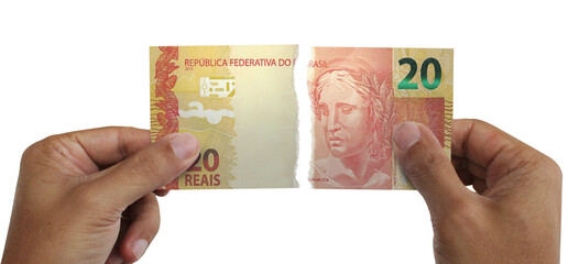 Torn money. Note of 20 reais. Currency of Brazil destroyed. Conceptual idea of ​​wasting money.