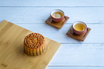 Moon cake served with chinese tea. Mid-autumn festival concept. Copy space.