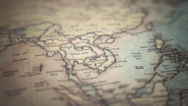 Thailand on a vintage political world map. Slow motion, tracking arc shot. 