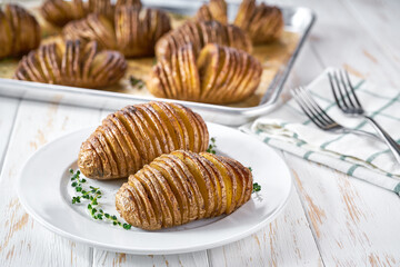 Baked hasselback potato. An accordion baked potato with garlic, thyme and sea salt.  Delicious vegetarian food.