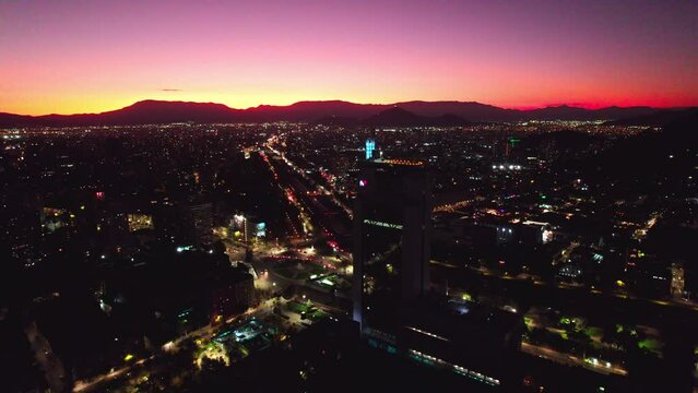 Aerial Drone Fly Above Sunset in Barrio Italia Santiago Chile Providencia Magenta and Yellow Skyline and Illuminated Neighborhood Establishing Shot
