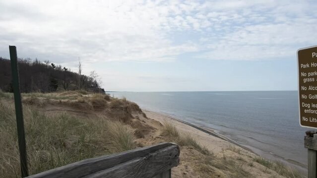 Eroding dunes in relief against the lakefront of Lake Michigan.