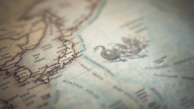 Japan on a vintage political world map. Slow motion, tracking arc shot. 