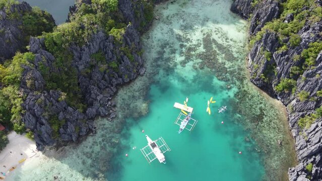 Scenic aerial over dramatic limestone karsts and Small Lagoon, El Nido Palawan