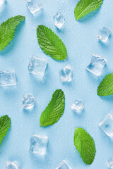 Ice cubes and fresh mint leaves, isolated on blue background