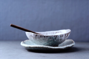 Traditional, handcrafted ceramic on  dark background. Soft focus. Close up. Copy space.                                                            