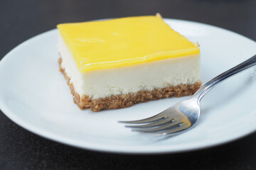 lemon cheese cake on plate on table 