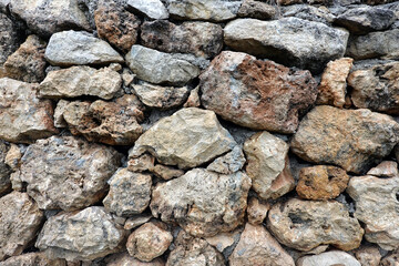 Old stonework from old natural stones as background front view close up