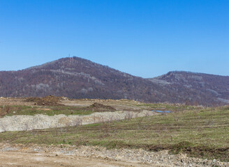 bulk created road, rocks from the ground - limestone material of volcanic origin, mountainous terrain, close-up.