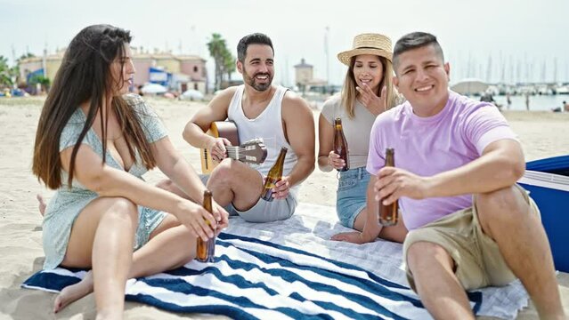 Group of people smiling confident toasting with bottle of beer at beach