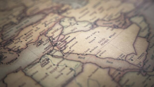 Middle East (Israel, Syria, Egypt, Jordan, Lebanon, Iraq, Saudi Arabia) on a vintage political world map. Slow motion, tracking arc shot. 