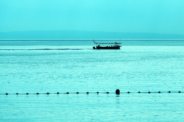 Silhouette of sailing boat at Kvarner bay of Adriatic sea in summer morning