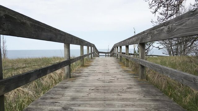 Point of View of walking on an old boardwalk. Pulling Back.