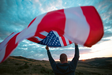 Man holding a waving american USA flag.