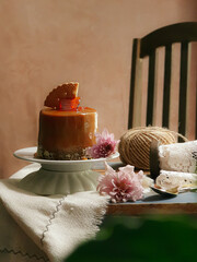 Round shape slices piece of dark chocolate fudge cake topping with cookies on white plate isolated agains brown background. Homemade bakery concept for birthday cake or valentine dessert.