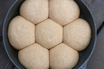 Bread roll dough balls in a frying pan