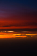 Dramatic sunset sky with orange red and blue shades. Aerial sunset landscape photo.