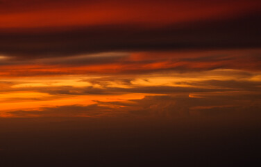 Dramatic sunset sky with orange red and blue shades. Aerial sunset landscape photo.