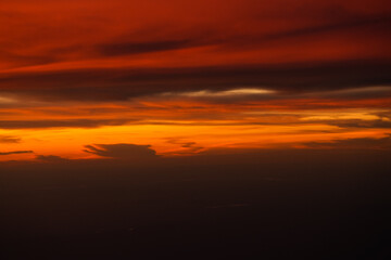 Fototapeta na wymiar Dramatic sunset sky with orange red and blue shades. Aerial sunset landscape photo.
