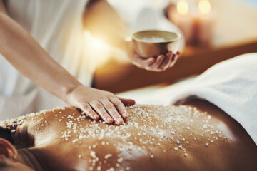 Obraz na płótnie Canvas Woman, hands and relax in salt scrub for skincare, exfoliation or relaxation at indoor beauty spa. Hand of masseuse rubbing salts on female back for physical therapy, massage or treatment at resort
