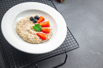 oatmeal porridge with berries tasty breakfast healthy meal food snack on the table copy space food background rustic top view
