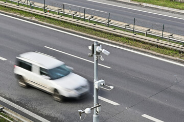 Traffic surveillance camera with white car in the background