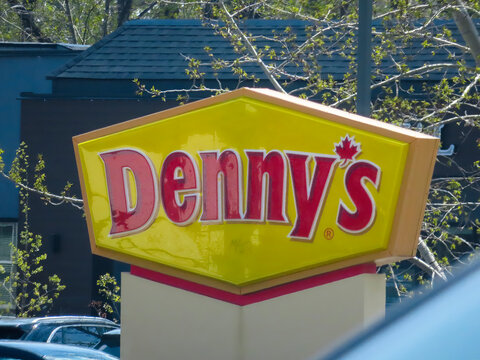 Calgary, Alberta, Canada. May 7, 2023. A close up to a Dennys fast food restaurant sign.