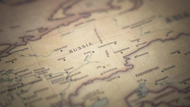 Russia on a vintage political world map. Slow motion, tracking arc shot. 
