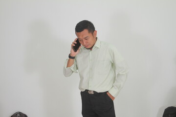 young businessman confused and serious while making a phone call
