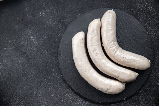 Raw white sausage weisswurst veal, pork, lard, spices natural meal food snack on the table copy space food background rustic top view