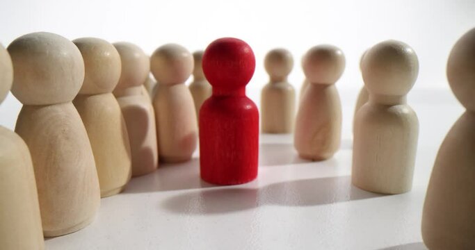 Wooden figurines crowd and one special. Stand out from crowd concept
