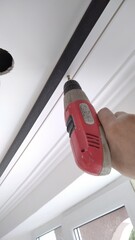 installation of the cornice to the ceiling using screws and a drill © Олег Струс