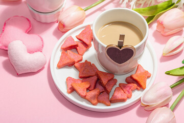 Valentine's Day romantic concept. Morning coffee, a bouquet of tulips, symbolic decor