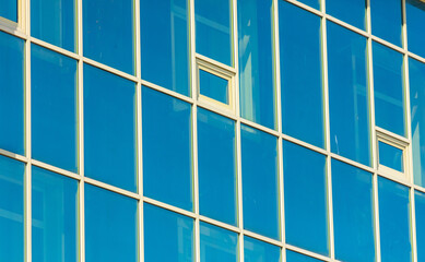 Reflection of the facade of a modern building in a glass window
