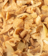 Close-up of sliced mushrooms with onions. The whole background