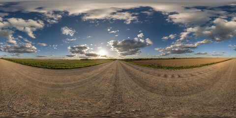 Fototapeta na wymiar panorama 360 hdri on gravel road with evening clouds on blue sky before sunset in equirectangular spherical seamless projection, use as sky replacement in drone panoramas, game development as sky dome