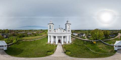 aerial full hdri 360 panorama view of white classicism catholic church in countryside with double...